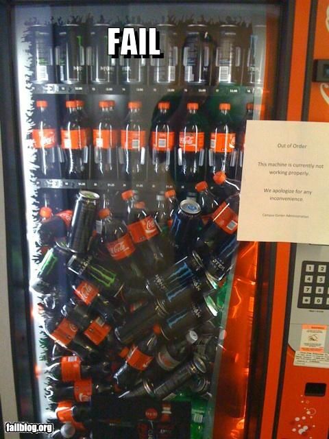 Vending machine with all of the sodas (coke, monster, sprite, etc) piled up in front because it no longer dispenses.