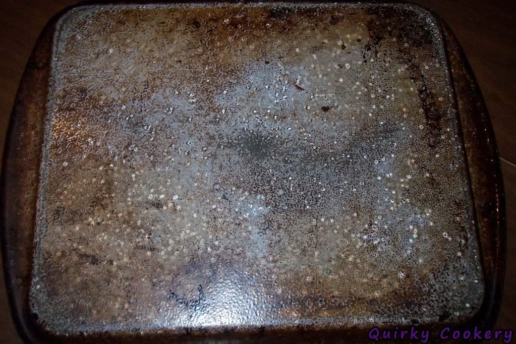 Back of a dark pan that looks speckled
