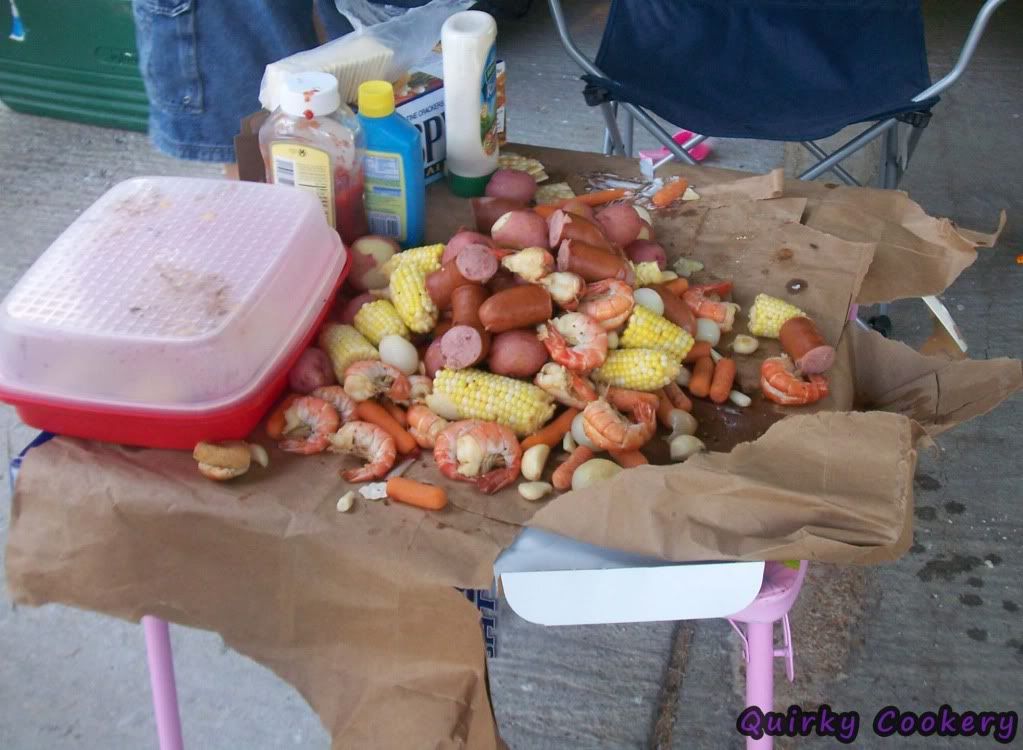 Shrimp boil with corn on the cob, garlic, polish sausage, carrots. 