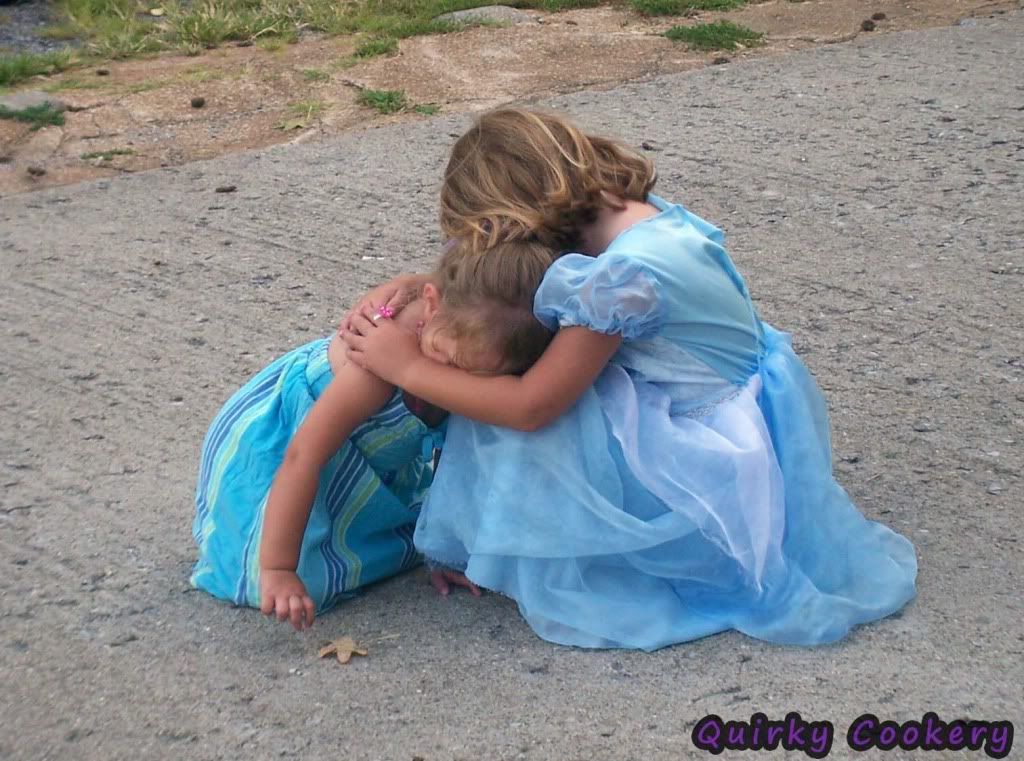 Older sister hugging and comforting younger sister who was hurt