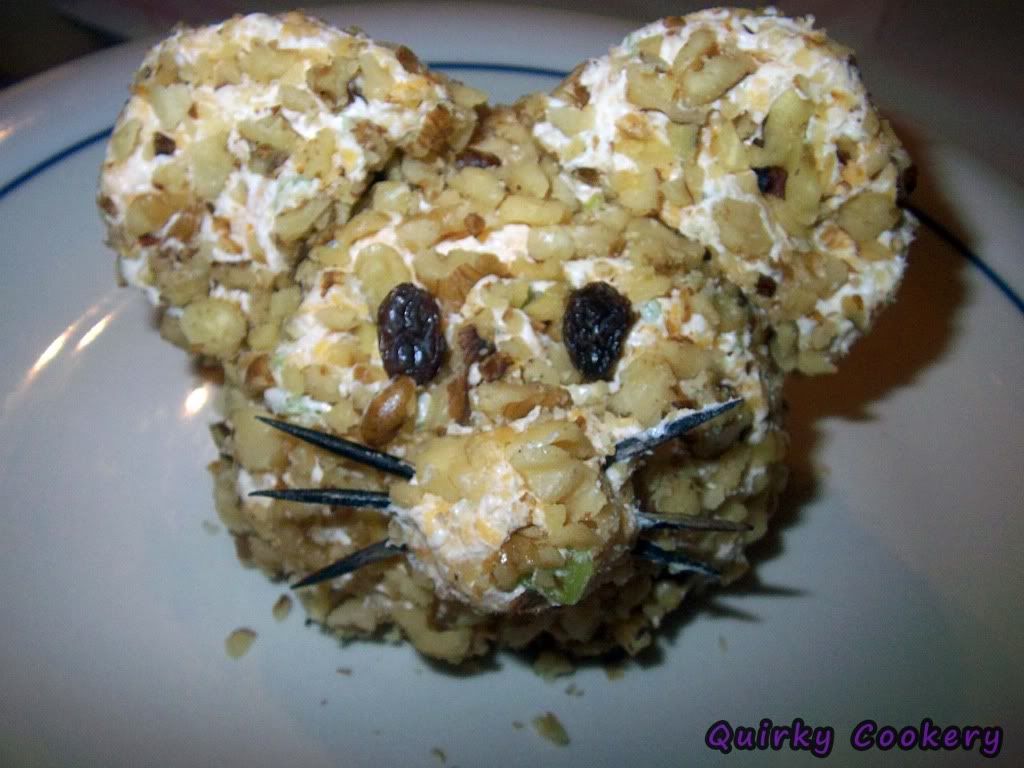Cheeseball with cream cheese, cheddar cheese, walnuts, pecans shaped like a mouse with a toothpick nose - Edible food art look-a-like