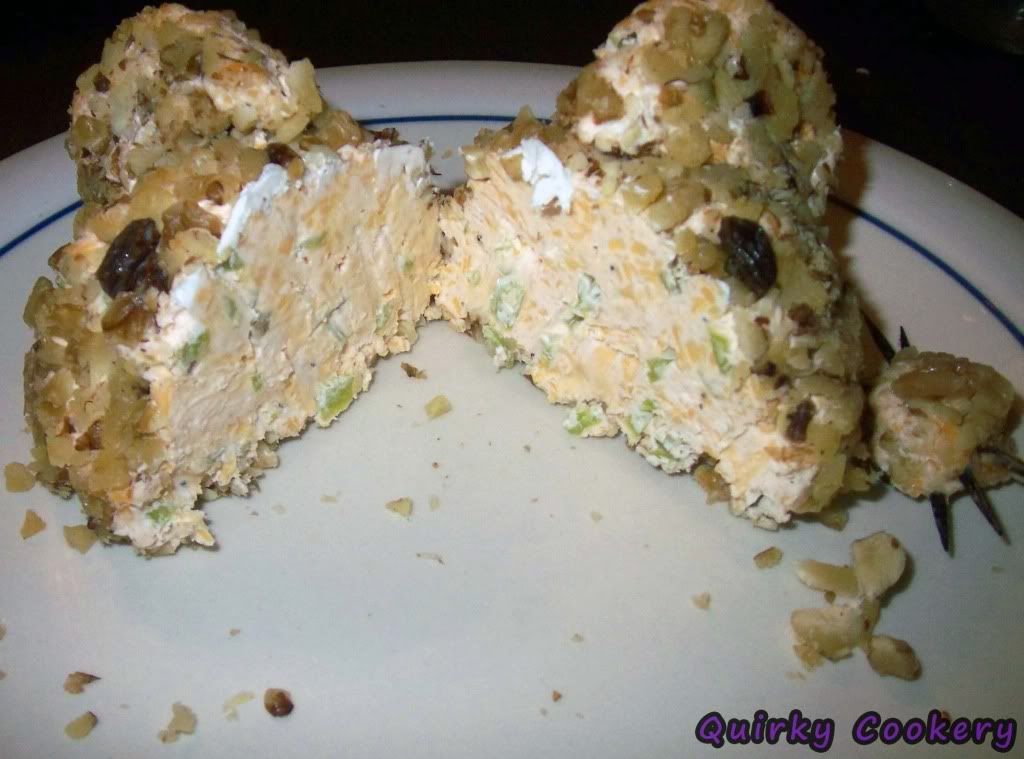 Inside of a cheeseball with nuts and peppers
