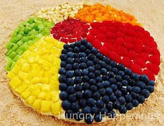 Make a sugar cookie dessert pizza with powdered sugar icing and lots of fruits - blueberries, raspberries, strawberries, oranges, bananas, mellon, pineapples - to look like a beach ball
