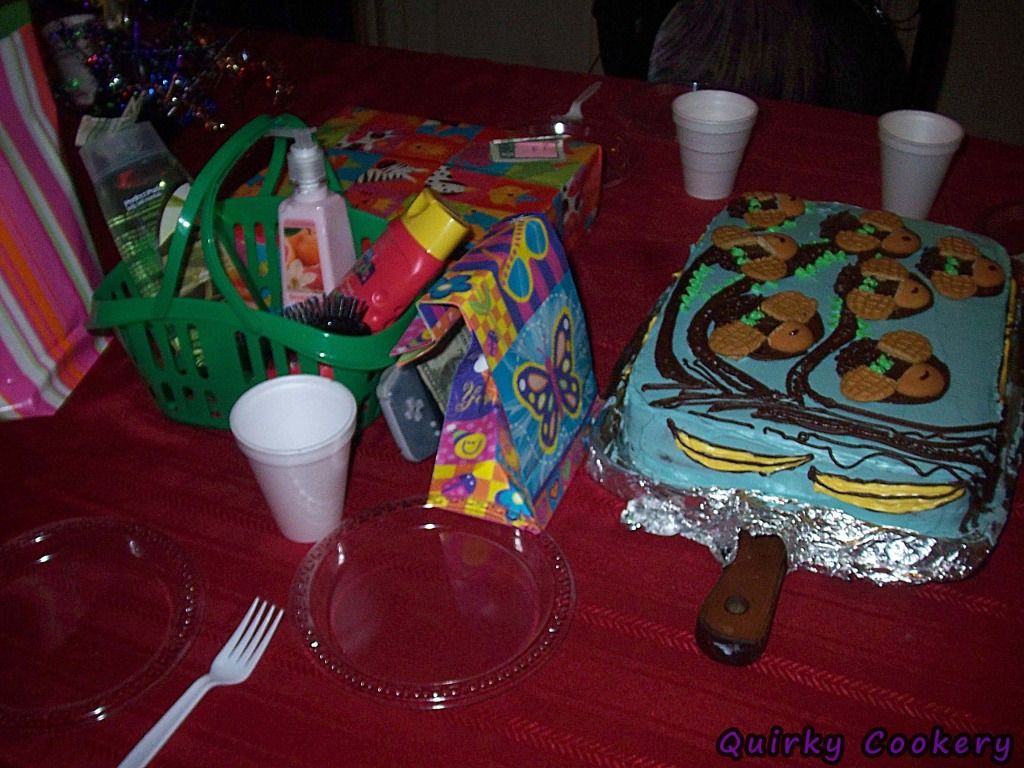 Monkey birthday cake table with presents and plates