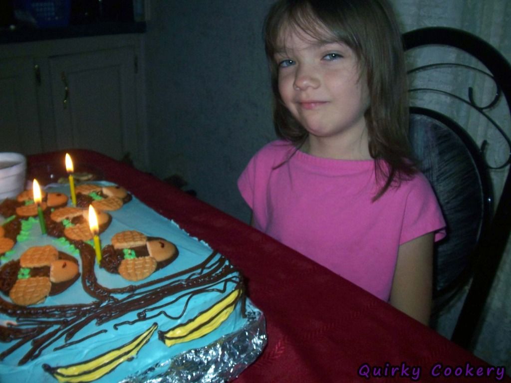 Little girl blowing out candle for birthday cake