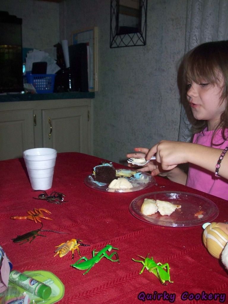 Eating birthday cake with plastic insect bug toys