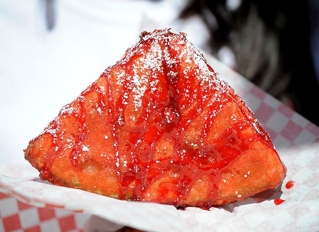 Up close picture of deep fried watermelon with powdered sugar and syrup