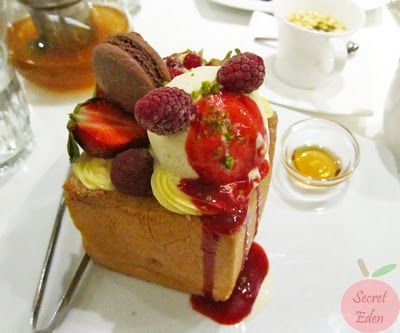 Honey toast dessert box with unsliced bread. Filled with toast, ice cream, raspberries, raspberry coulie, chocolate covered strawberries, and chocolate macarons