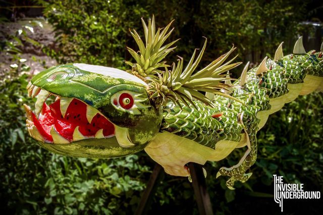 12 watermelons carved to look like dragon with pineapple ears and scaling