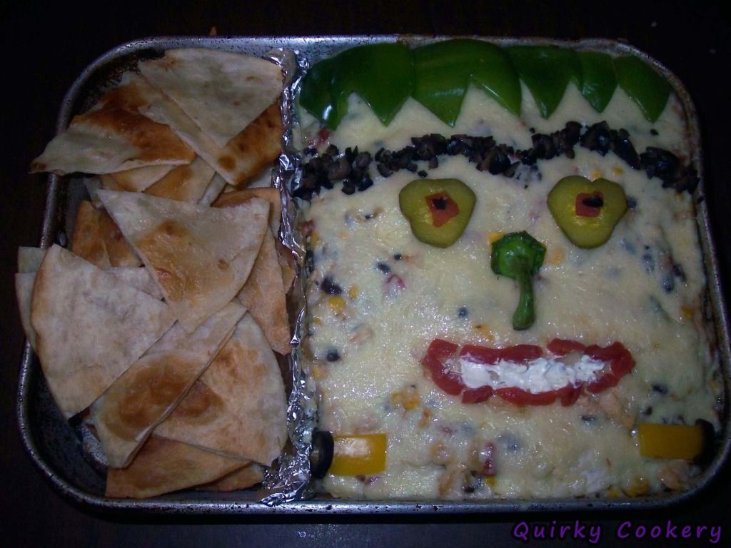 Frankenstein casserole with veggies for face; Homemade tortilla chips for dipping into black bean dipping and monster face for Halloween