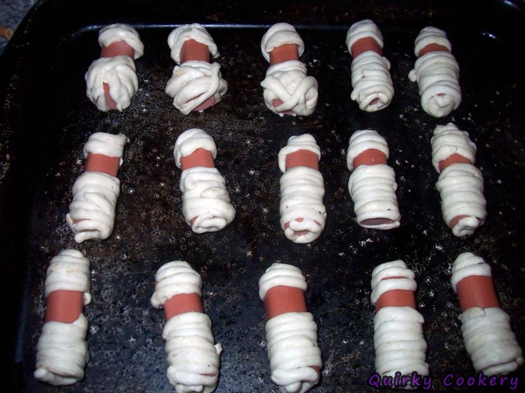 Halloween mummies made with hot dogs and fridge biscuit dough - uncooked