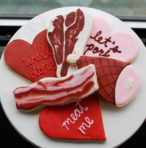 Meat cookies for men. Decorated to look like bacon, ham, and a t-bone steak. The hearts say "well done," "let's pork," and "meat me." 