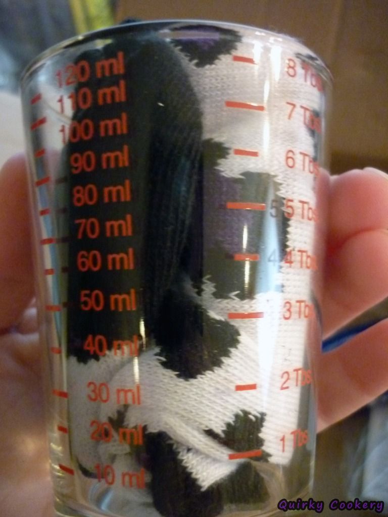 Shot glass that has both metric and standard measurements