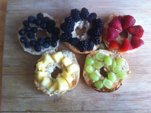 Bagels and cream cheese with fruit toppings to look like Olympic rings - blueberries, blackberries, strawberries, pineapple, green grapes - blue, black, red, yellow, green