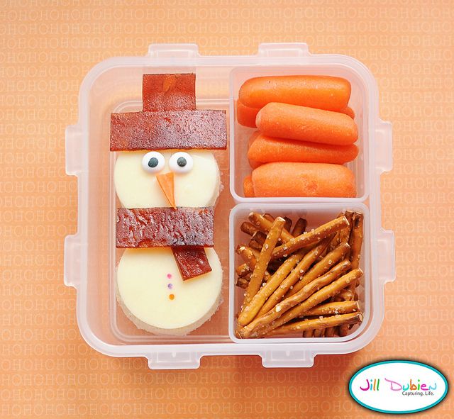 Bento box - Ham and cheese sandwich snowman with pretzel and carrots on teh side