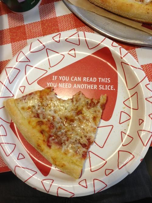 Paper plates that have triangles on it that say "If you can read this, you need another slice."