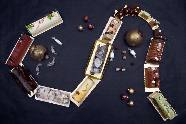 Buche de noel train made up of fancy yule logs for Chrismas from NYC bakeries such as Balthazar, Benoit, Bouchon, Canelle Patisserie, Daniel Boulud (DBGB), Dominique Ansel Bakery, Epicerie Boulud, and Francois Payard Patisserie   