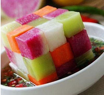 Chunks of fruit to look like rubik's cube where watermelon, honey do, and other various fruits stacked on top of each other. 