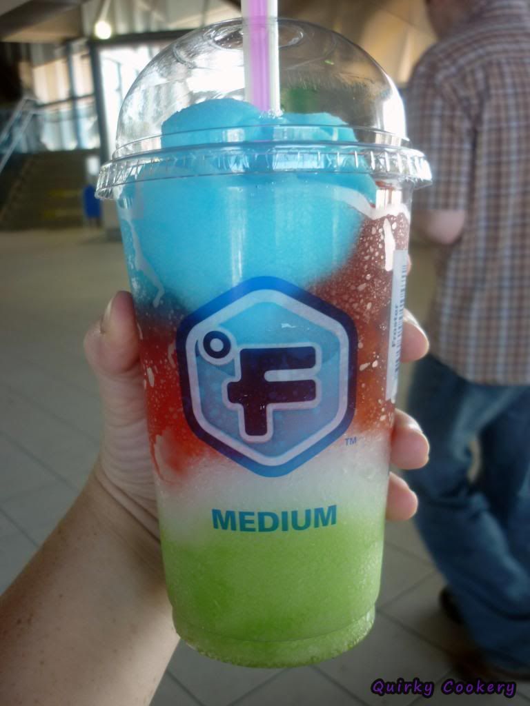 Medium slurpee with lime, blue raspberry, white and red strawberry options