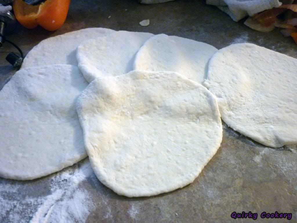 Flattened homemade pizza dough circles to make pork bun style pockets