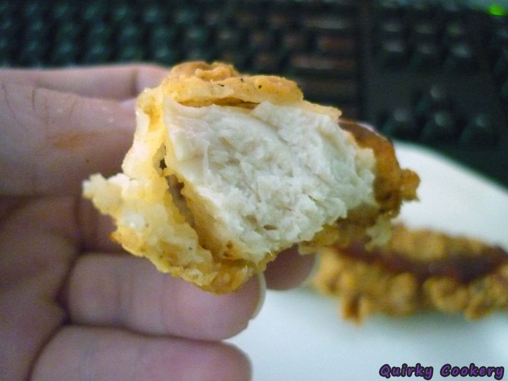 Bite of chicken with buttermilk batter crust peeling off