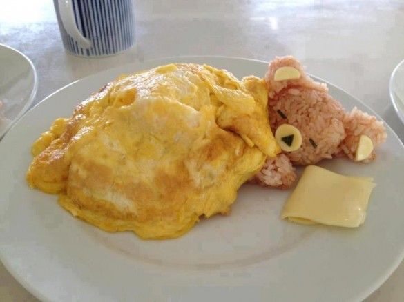 Sleeping rice teddy bear under an omelet blanket - Prop his head up with a sausage link and add cheese for faces and pillows