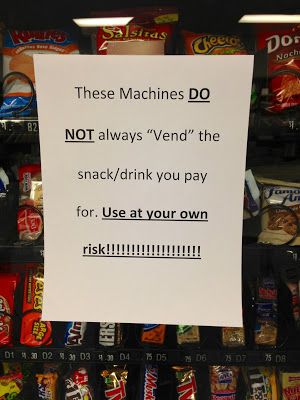Vending machine with the sign that says "These machines do not always vend the snack/drink you pay for. Use at your own risk!!!!" because it is broken. 