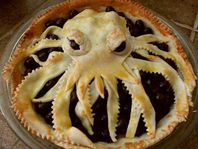 H.P. Lovecraft's Cthuhlu made out of a blueberry pie for dessert with tentacles like an octopus
